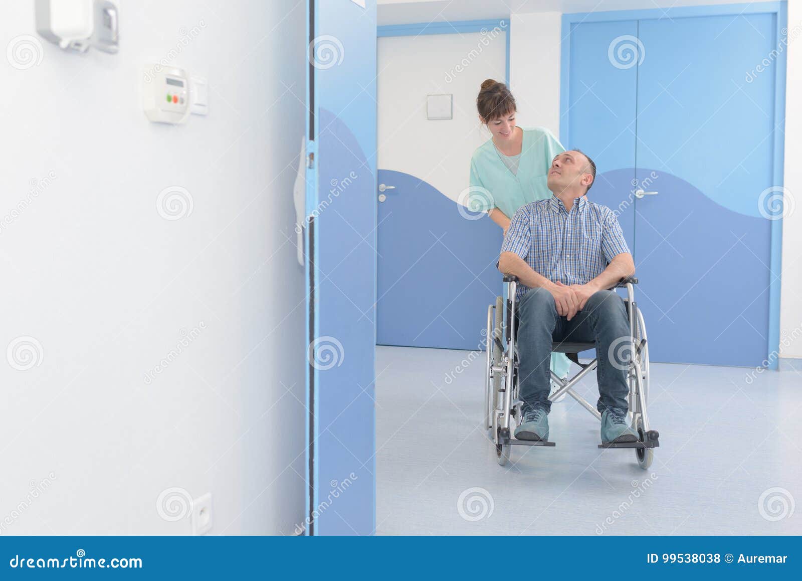 Disabled Man in Wheelchair and Nurse Pushing Him Stock Photo Image of