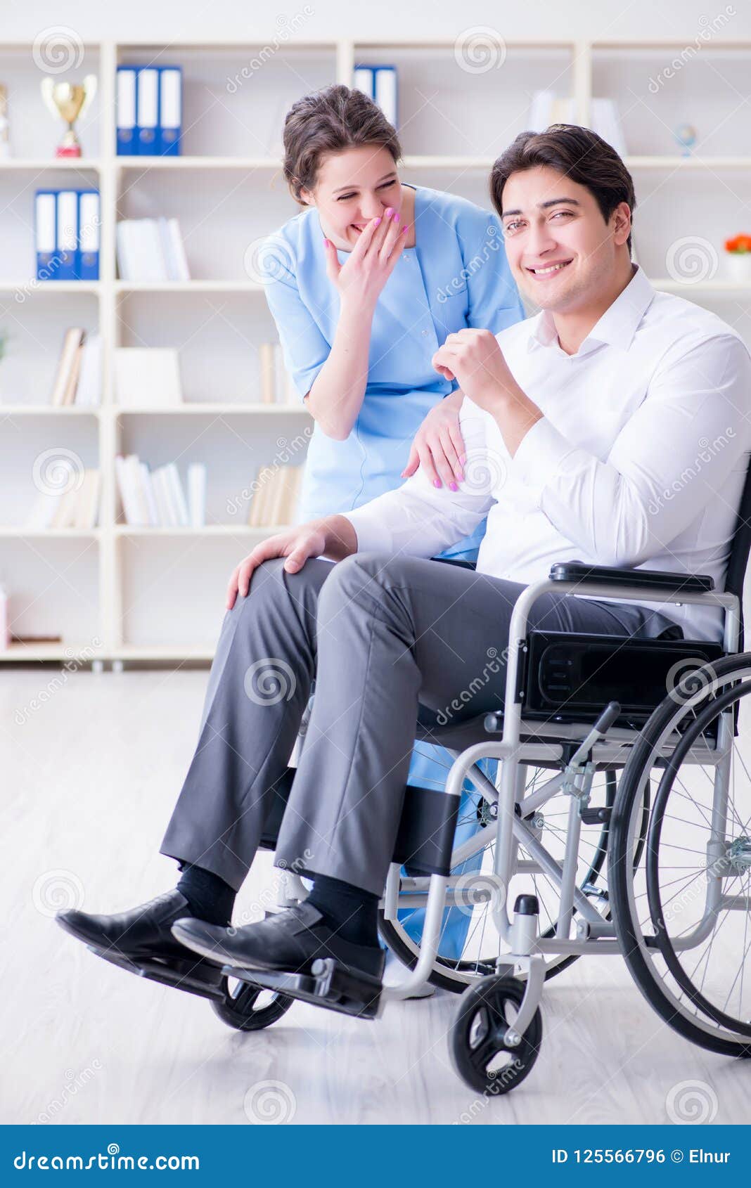 Disabled Patient on Wheelchair Visiting Doctor for Regular Check Stock