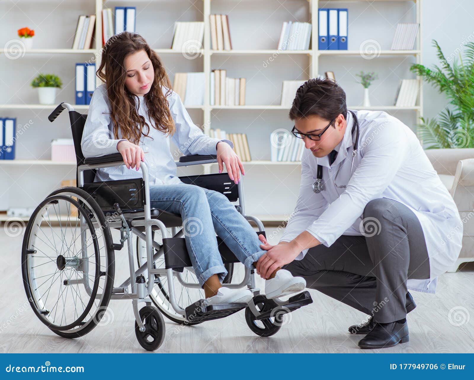Disabled Patient on Wheelchair Visiting Doctor for Regular Check Stock