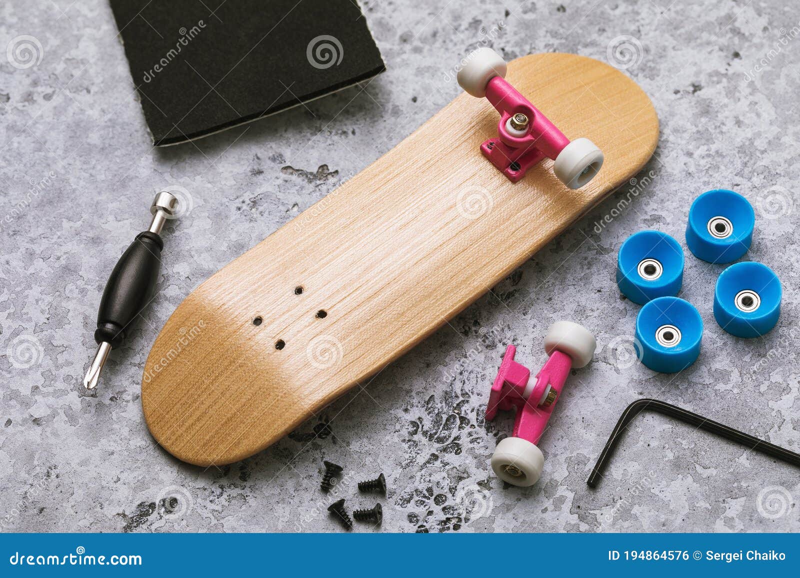 Disassembled Fingerboard and Various Accessories on the Table with Tools for Repair with Your