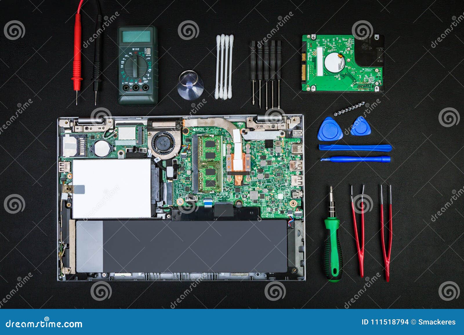 Disassembled Laptop With Computer Parts And Special Tools Stock