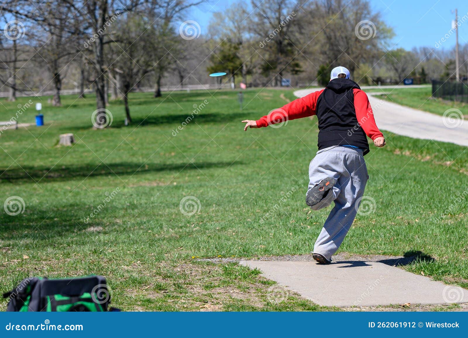 Disc Golf Player Throwing a Disc in the Park. Stock Photo Image of