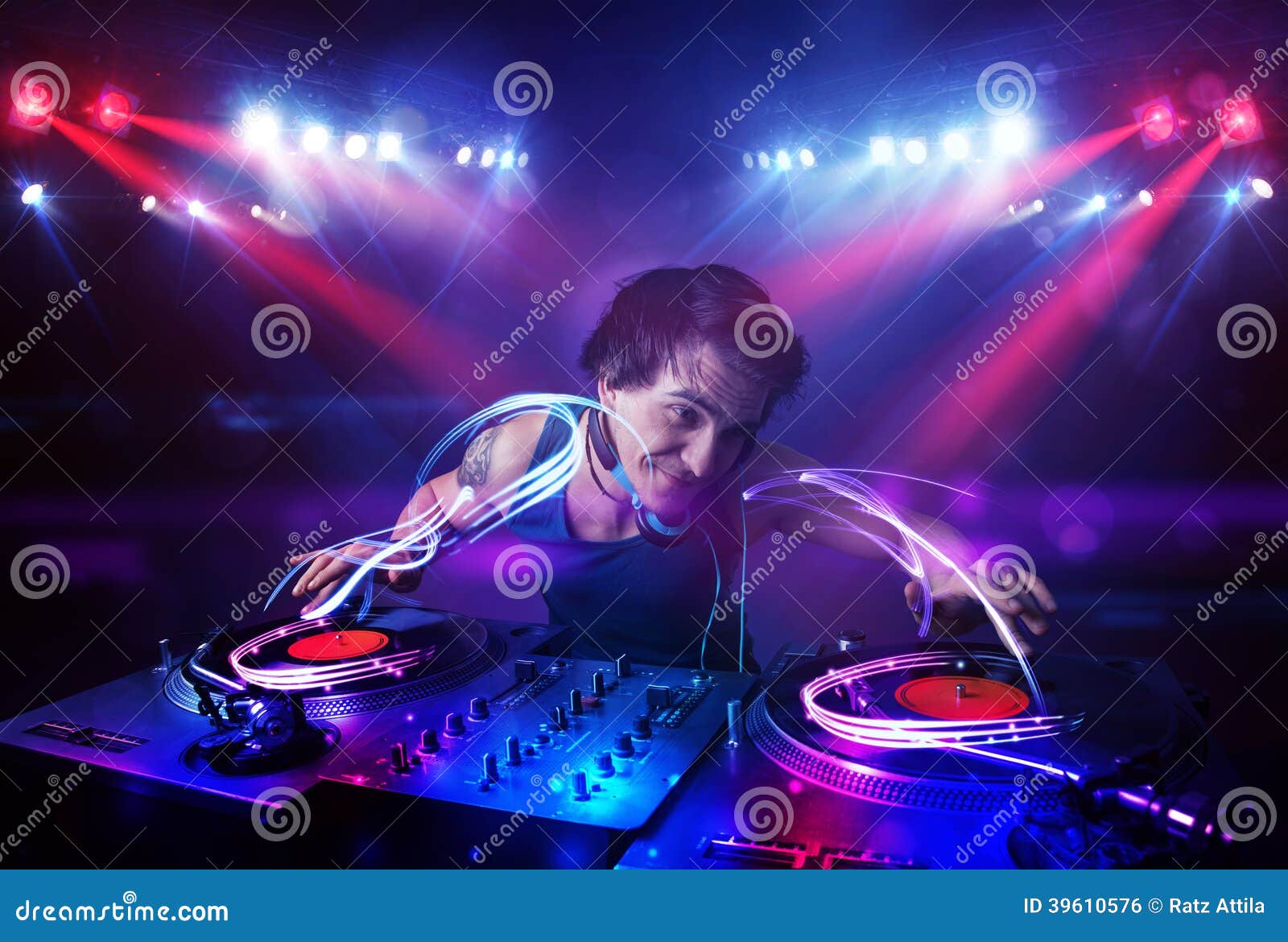 Disc Jockey Playing Music with Light Beam Effects on Stage Stock Photo