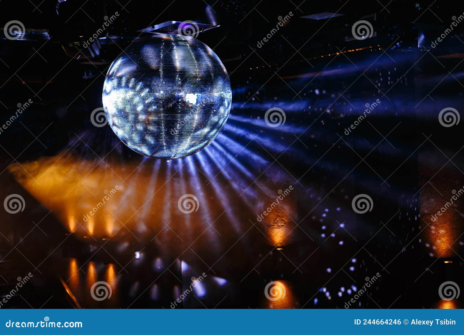 Disco Ball Hanging on the Ceiling of the Disco Rays of Light are