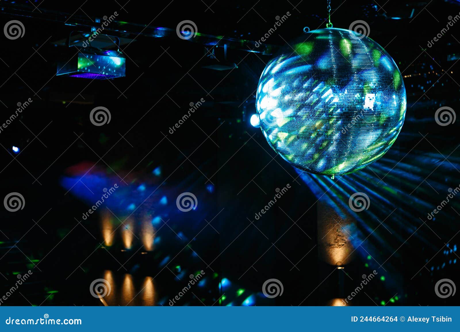 Disco Ball Hanging on the Ceiling of the Disco Rays of Light are