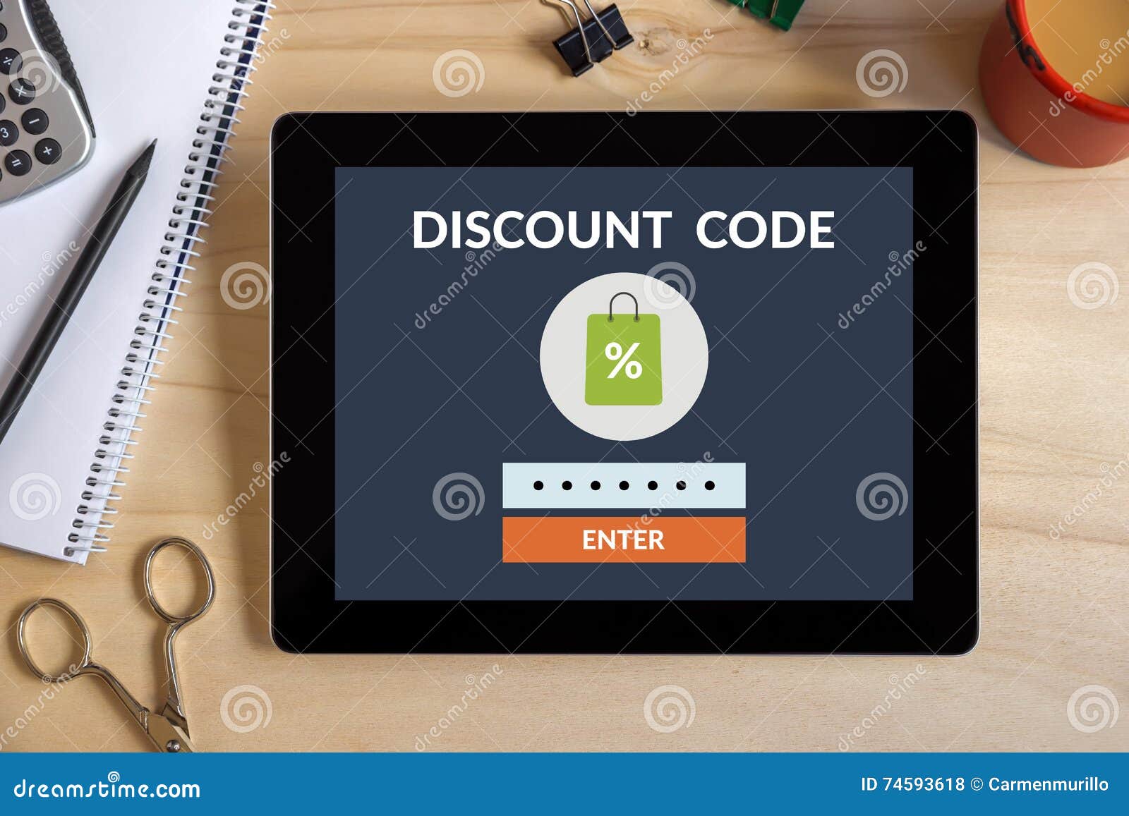 Discount Code Concept on Tablet Screen with Office Objects Stock Photo