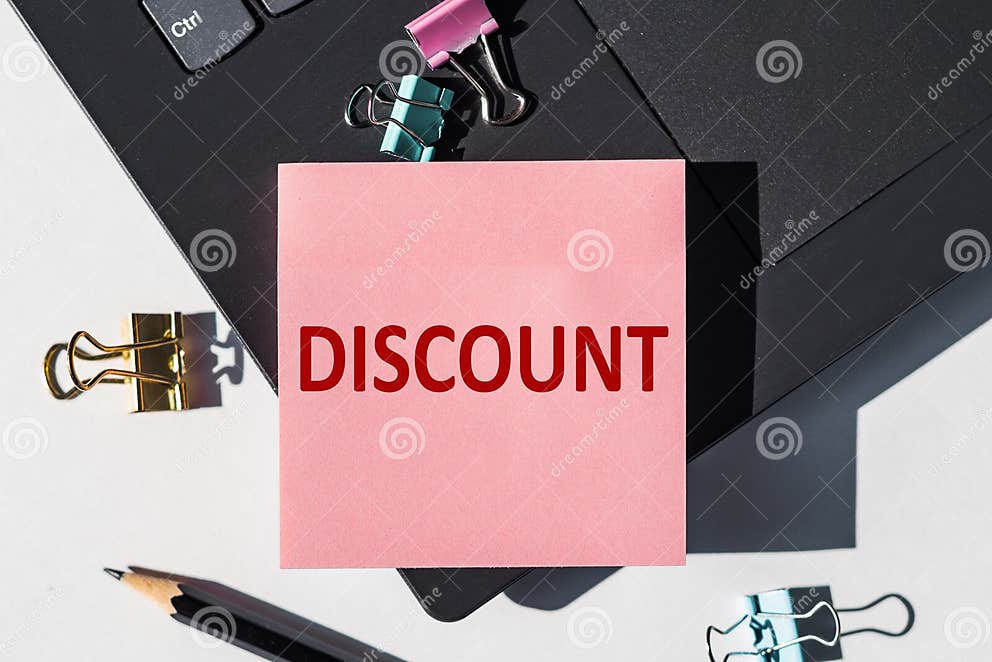 discount-note-is-written-on-a-paper-sticker-on-a-laptop-keyboard-stock