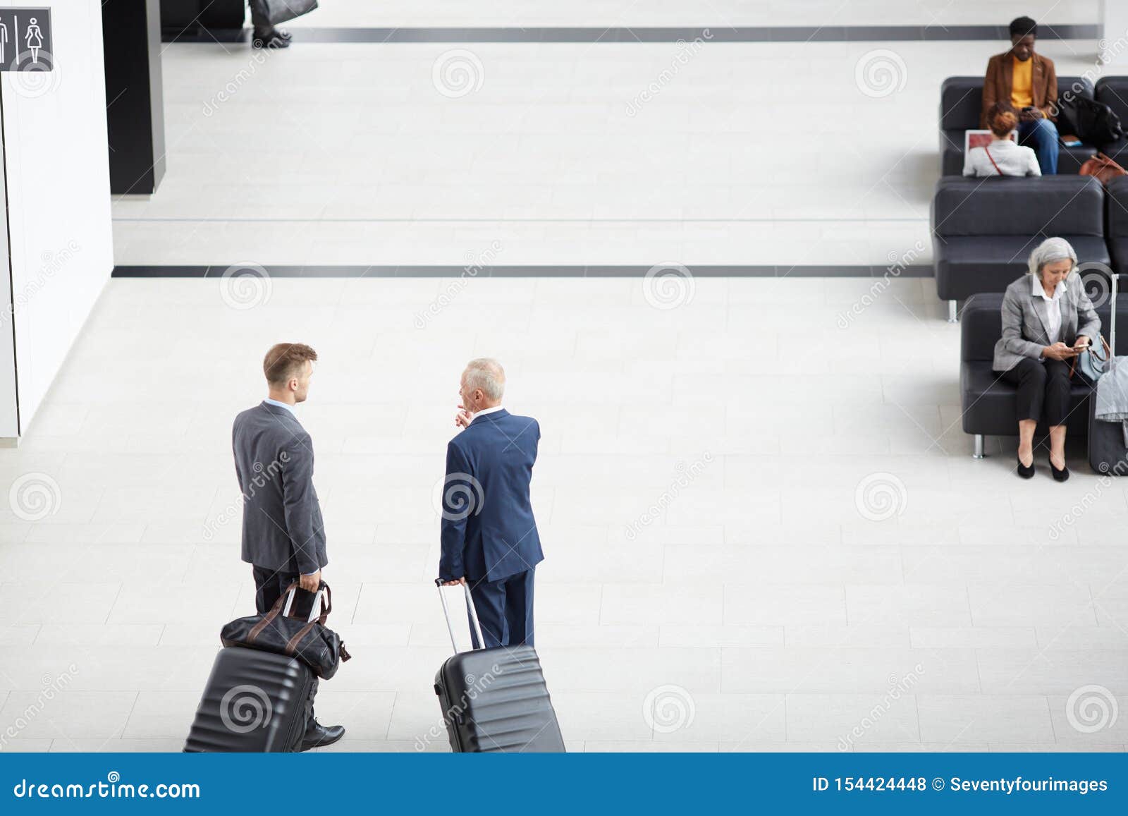 Discussing Business Trip in Airport Stock Photo - Image of airport ...