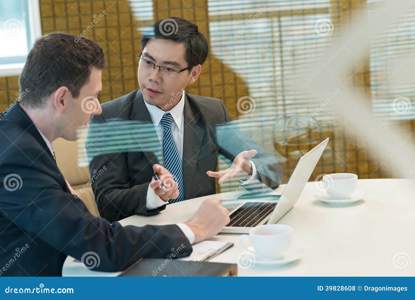 Discussion. Two businessmen discussing something during coffee break