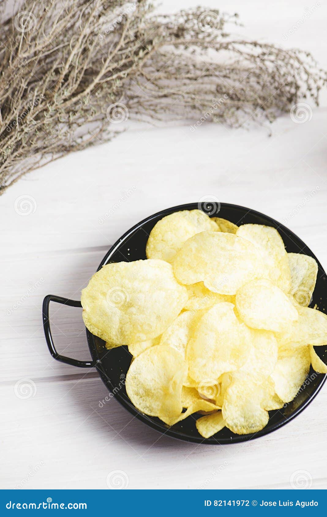A Dish with Chips Standing on Dark Gray Colored Wooden Table. Stock