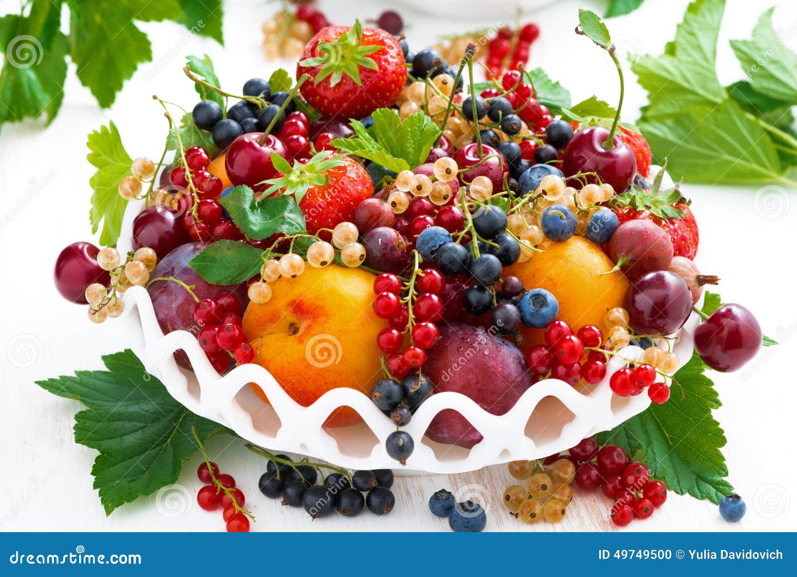 Dish with Different Fresh Seasonal Fruits and Berries on White Stock