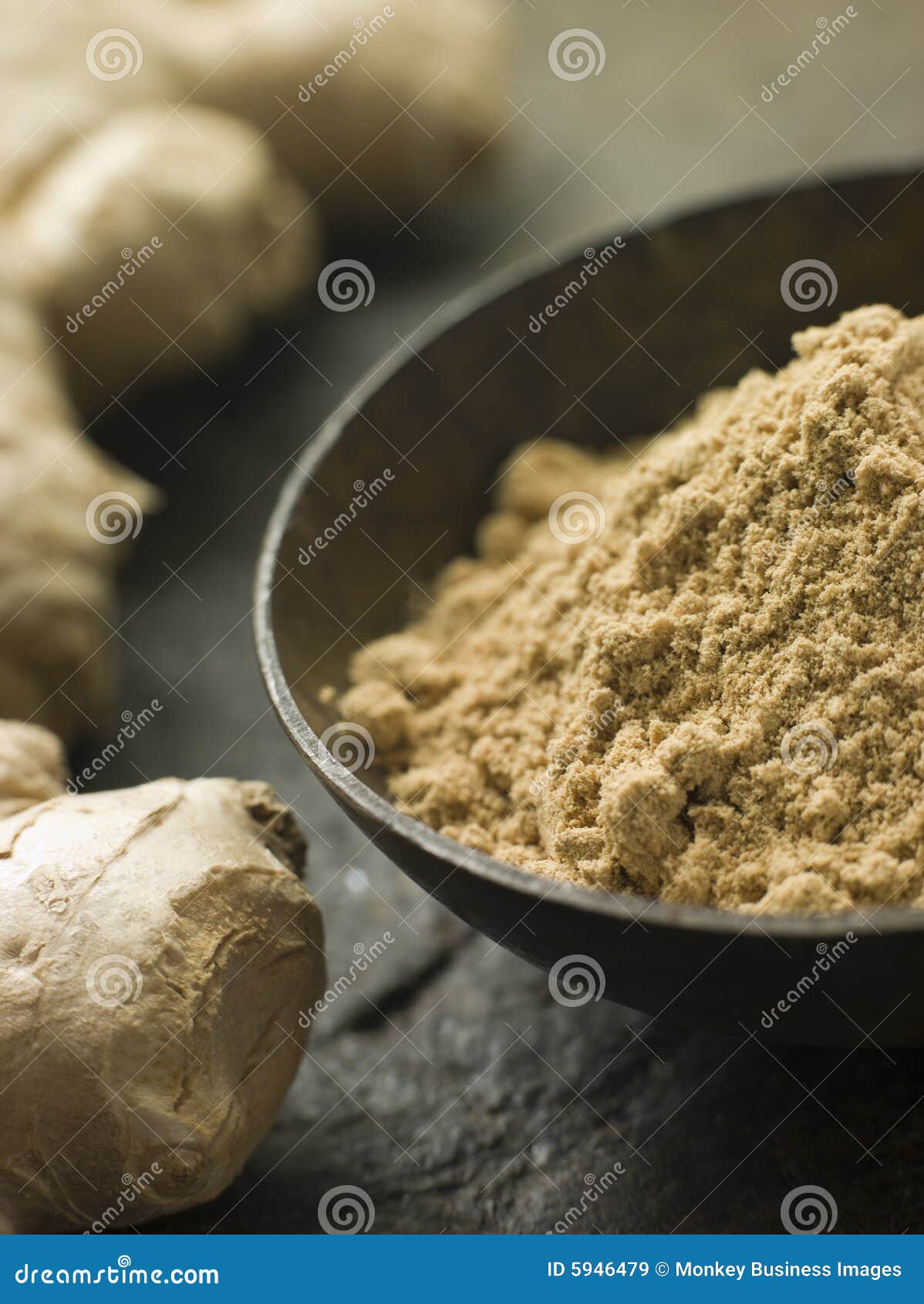 dish of ginger powder with fresh ginger root