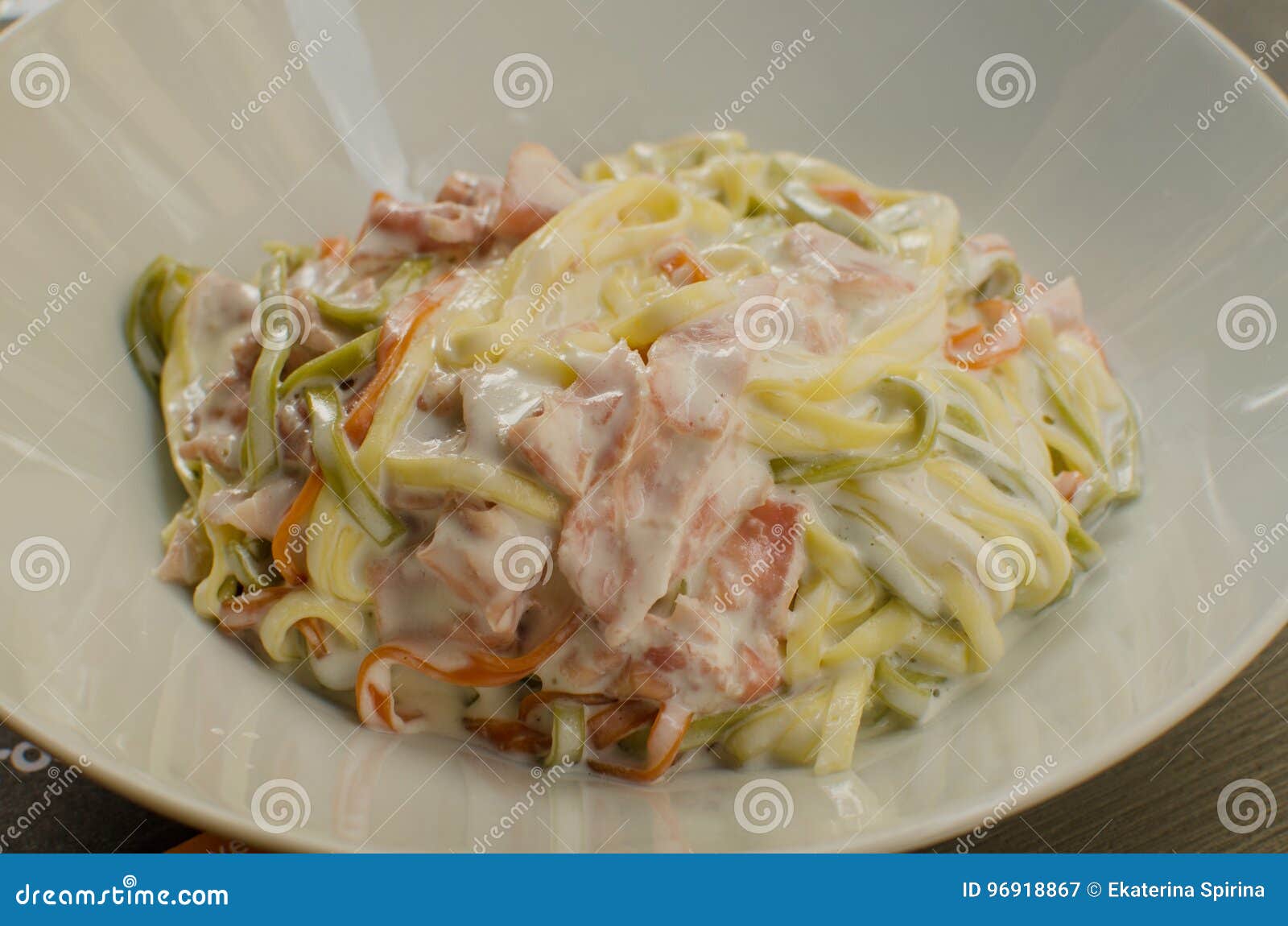 the dish `paglia e fieno al prosciutto` - typical italian food