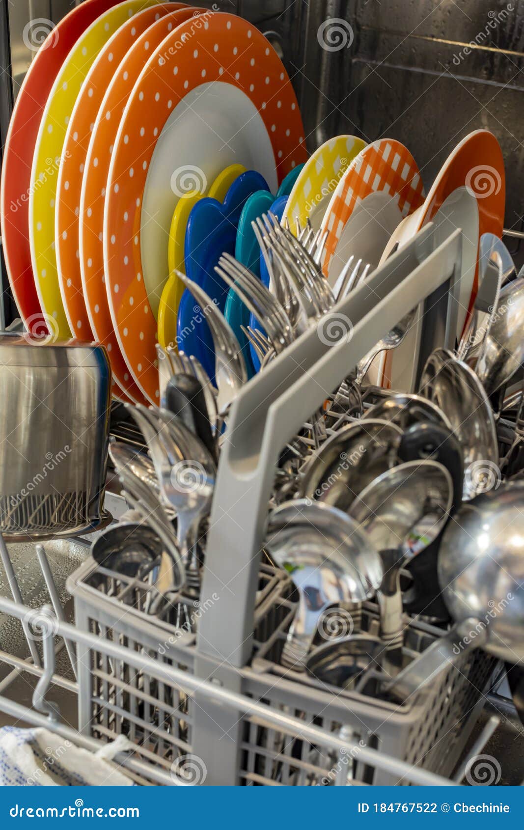 Dishes and Cutlery in a Dishwasher after the Wash Stock Photo Image