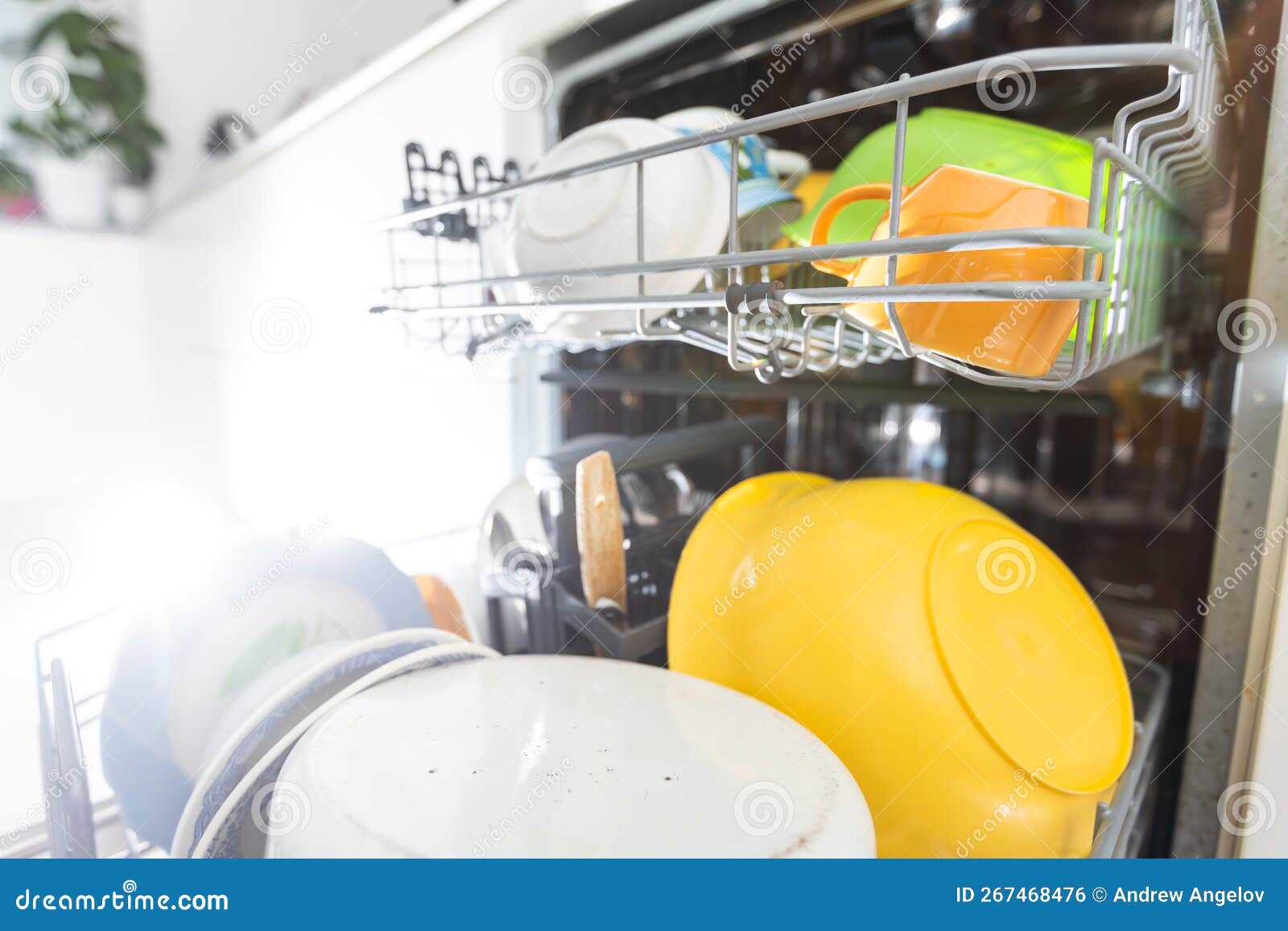 Dishes and Cutlery on Dishwashing Machine. Clean Dishes. Stock Photo