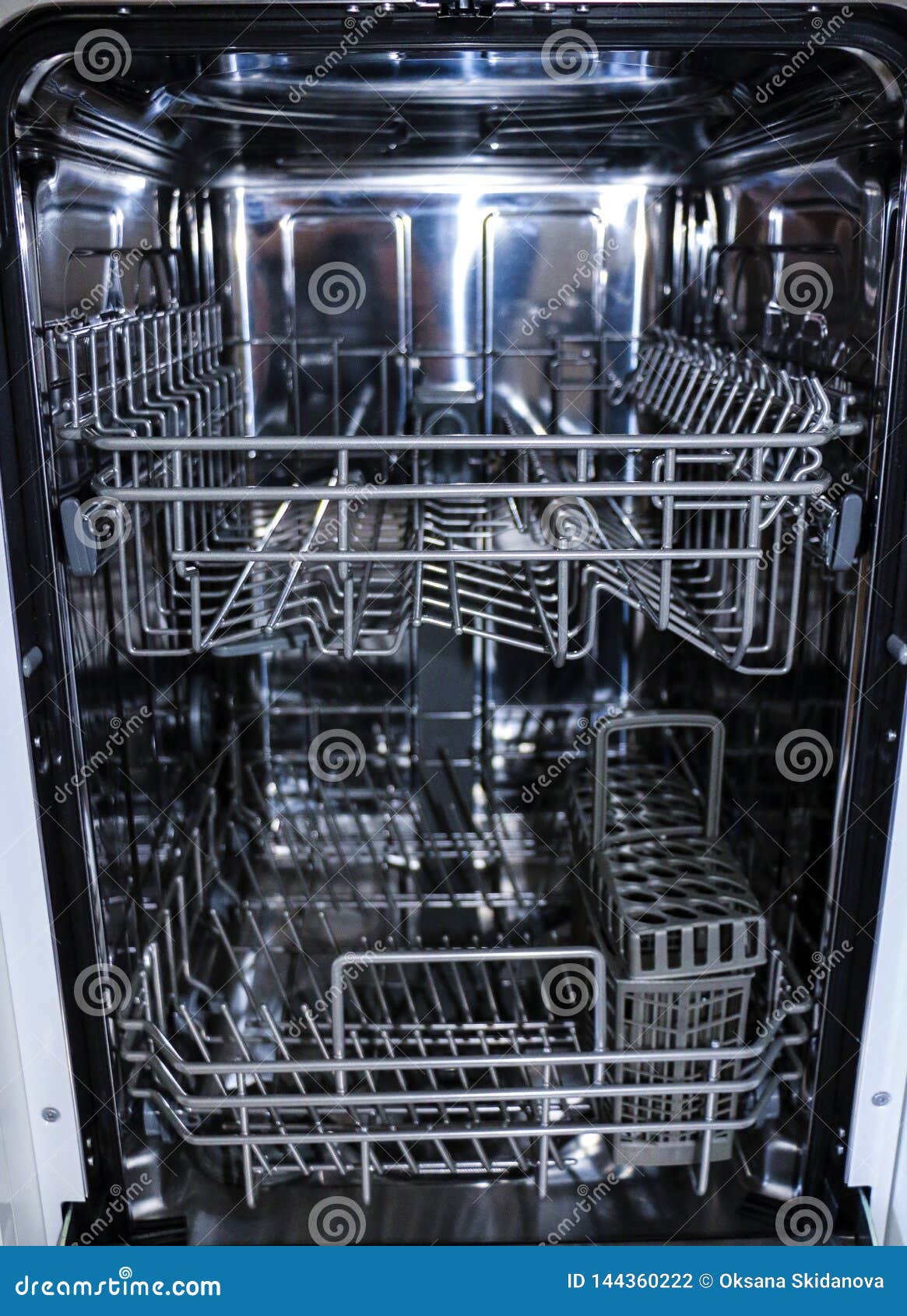 Dishwasher with Open Door. Internal Shelves of Dishwasher for