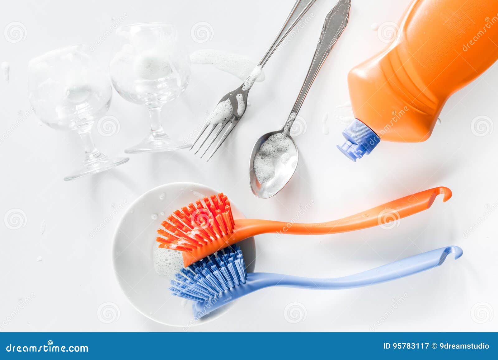 Dishwashing Liquid, Sponge, Brush and Tableware on White Background Top