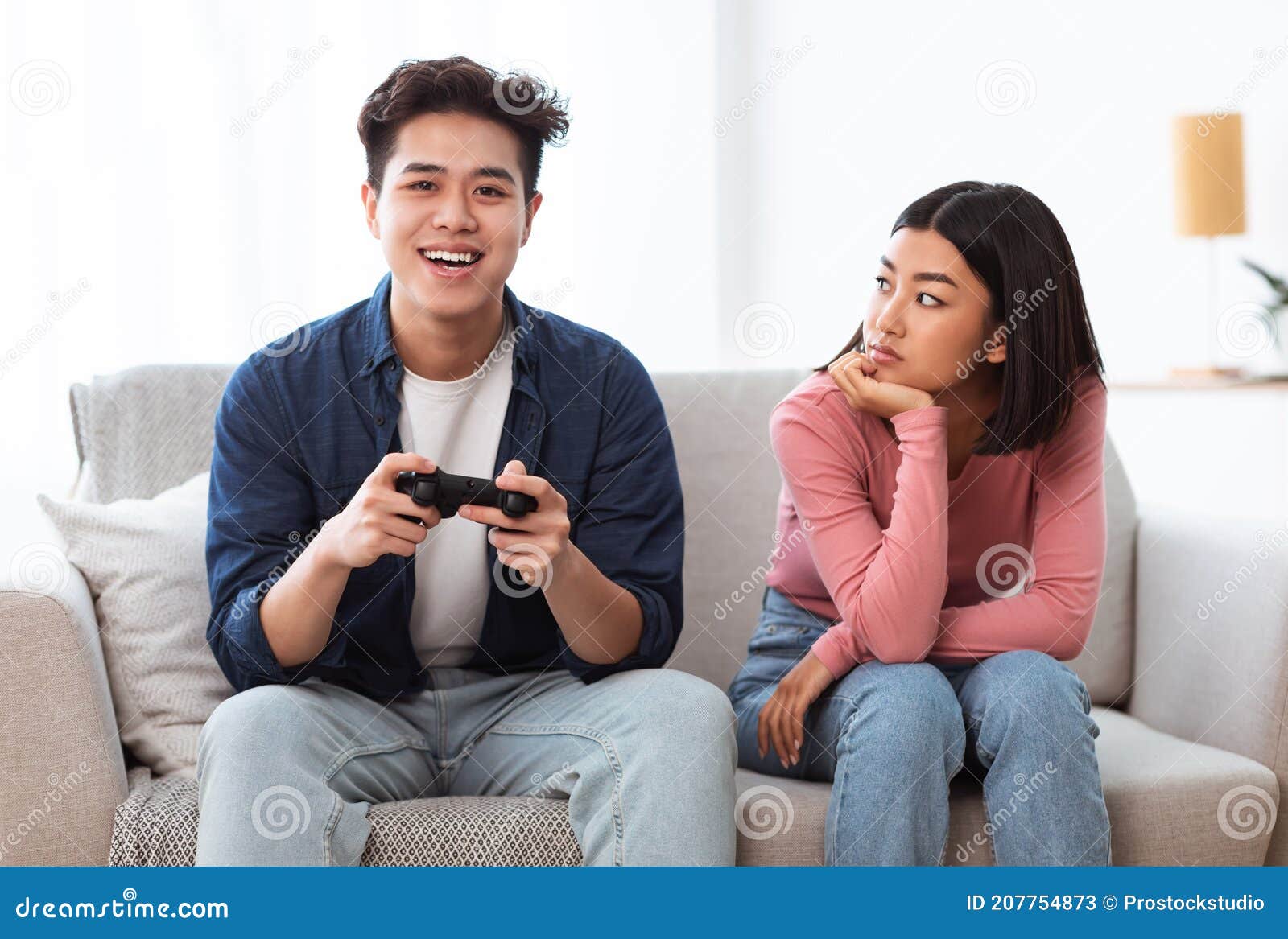 Boyfriend learning his girlfriend to play video games on