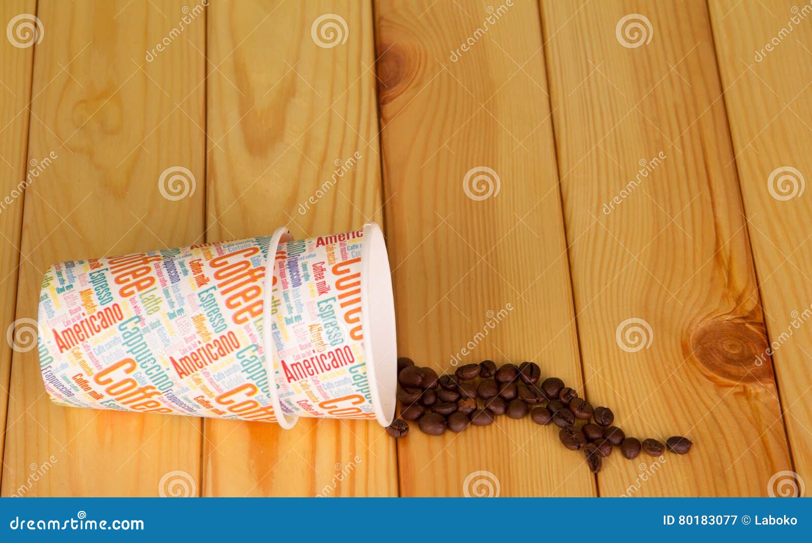 disposable paper cups and coffee beans on background light wood.