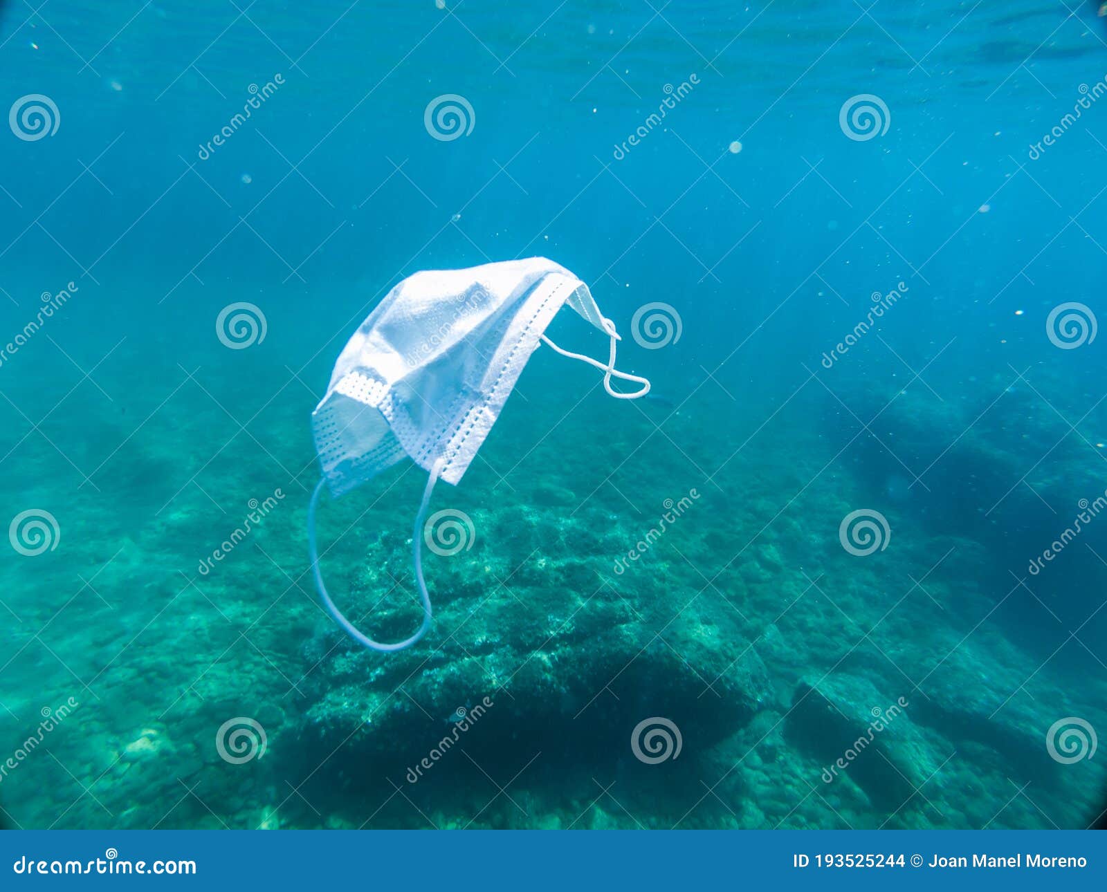 disposable protection mask under the sea, residues of the covid-19 pandemic