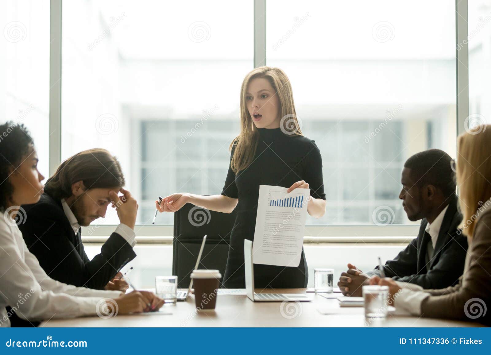 dissatisfied female executive scolding employees for bad work at