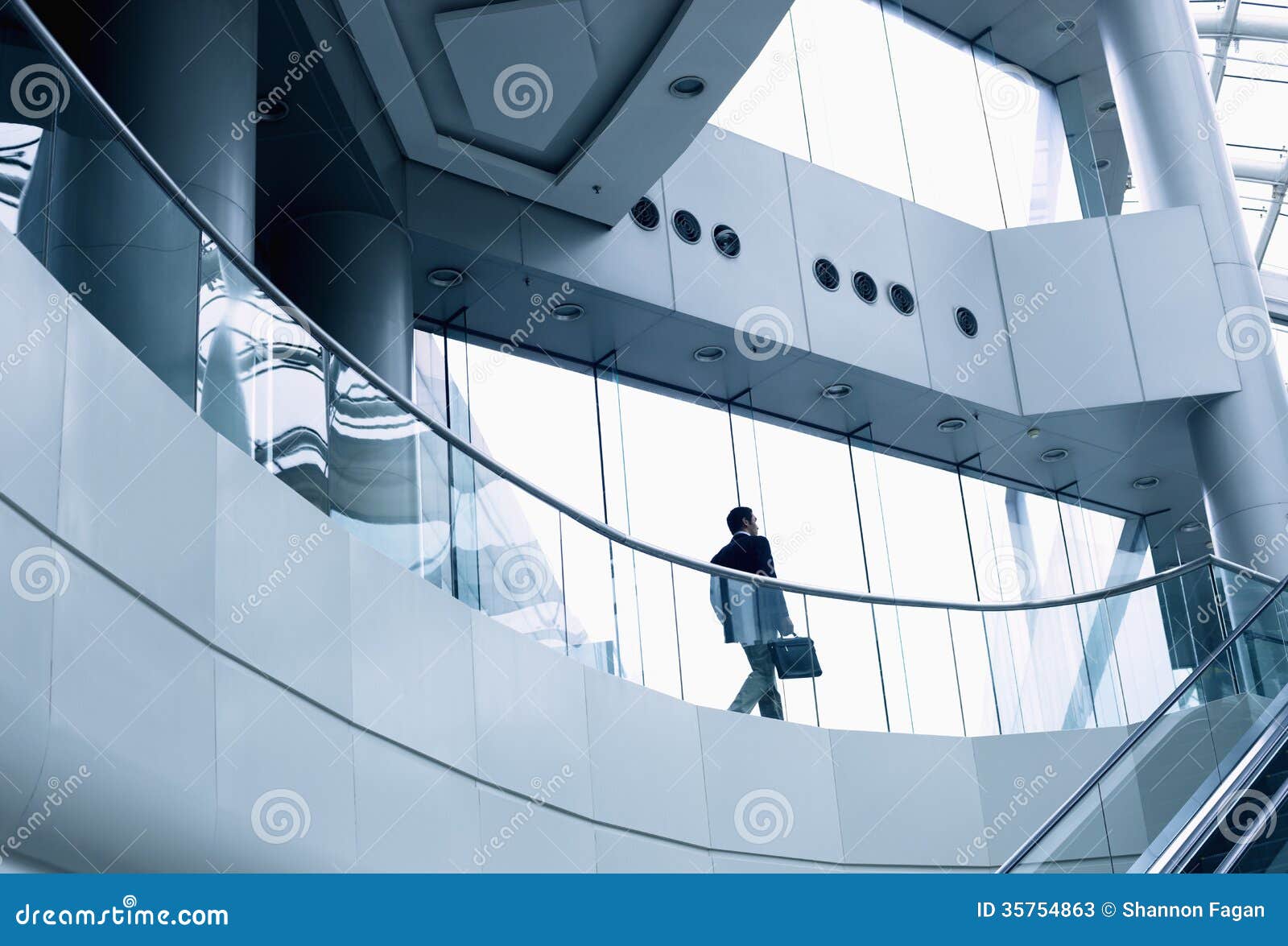 distant businessman walking in a modern office building