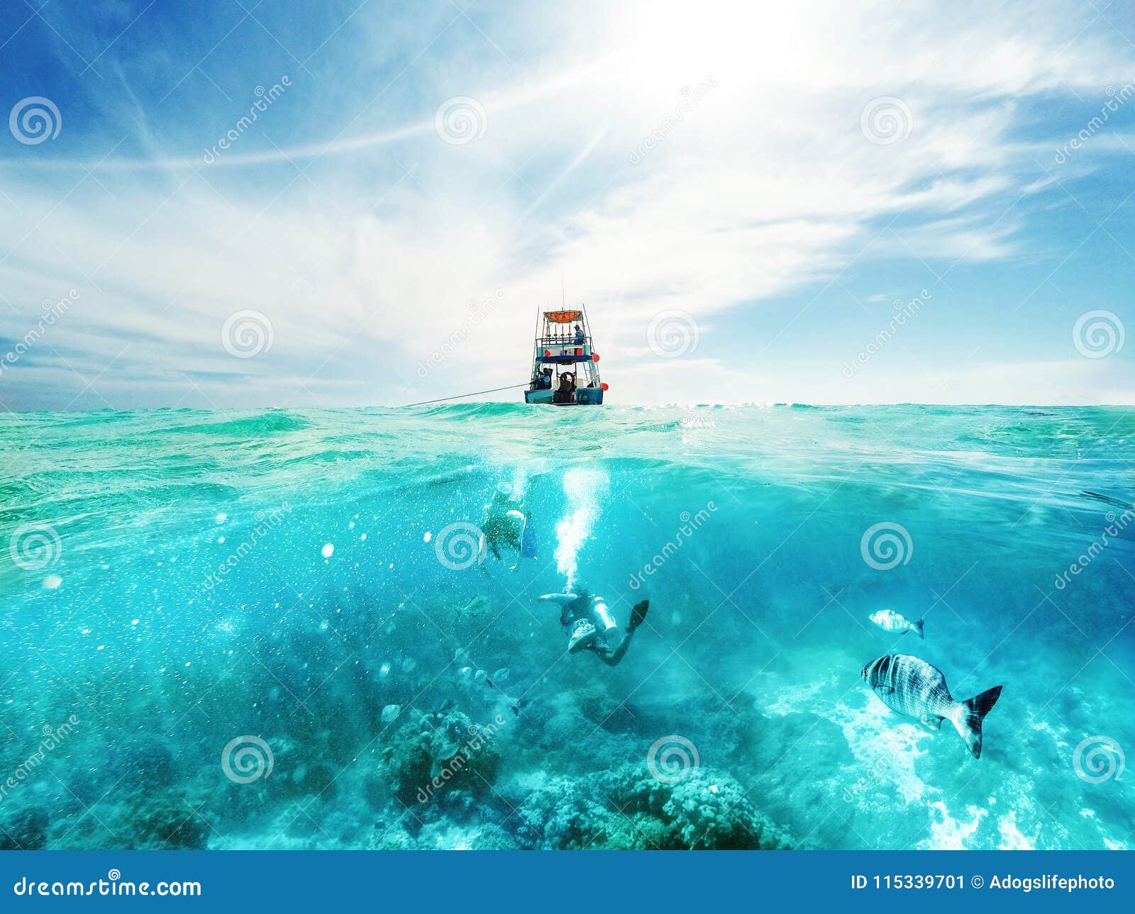 divers and boat in the caribbean sea