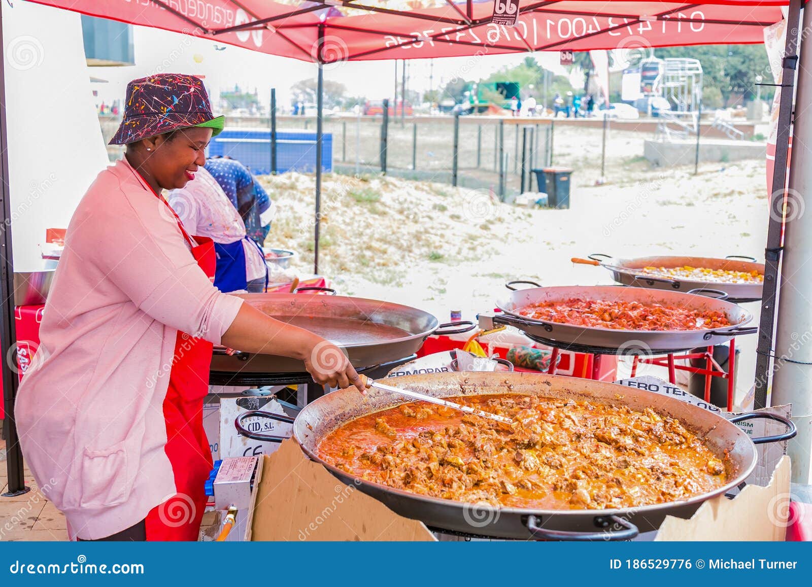 Diverse African Vendors Cooking and Serving Various Bread Based Street