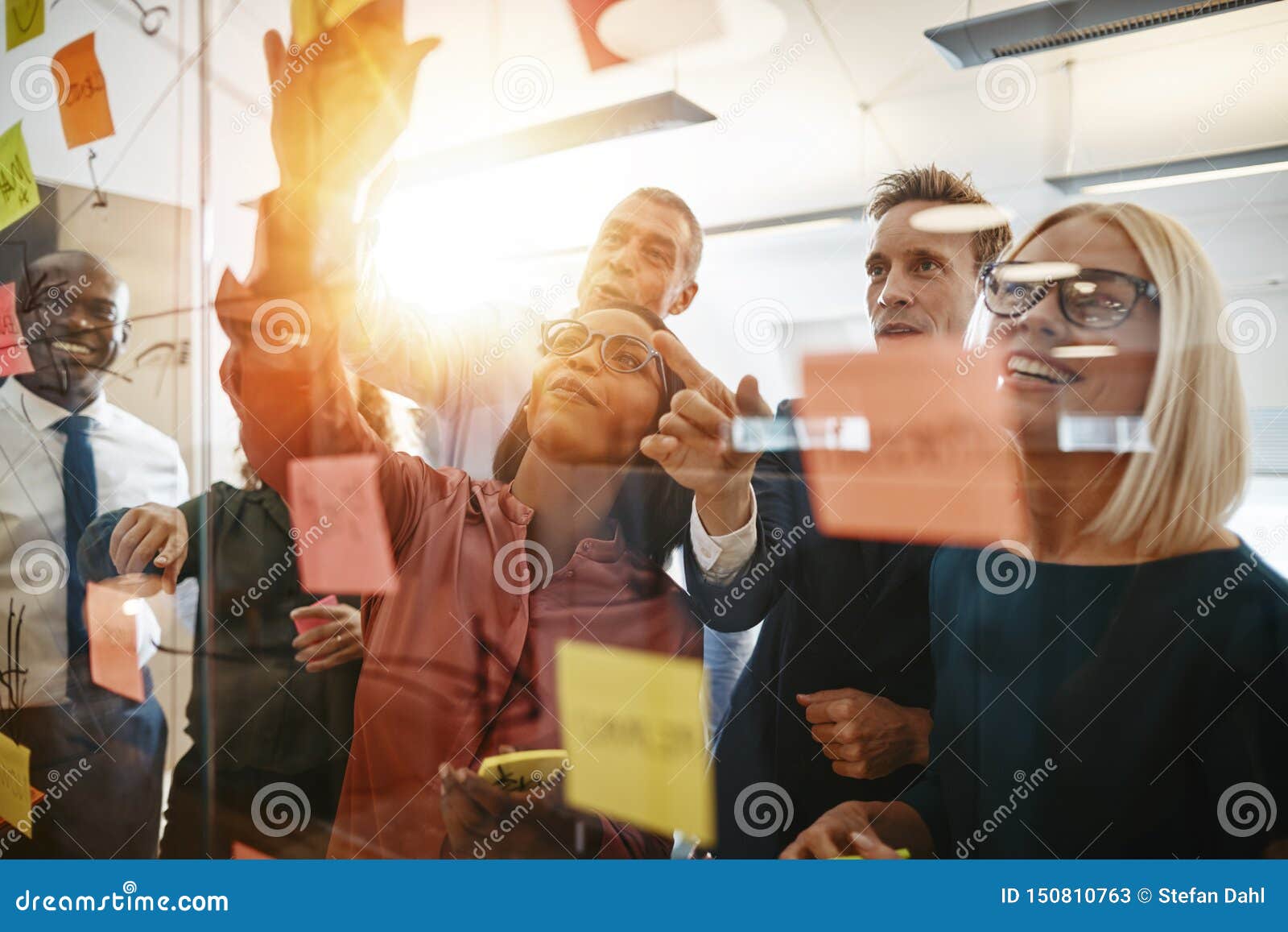 diverse businesspeople smiling during a brainstorming session wi