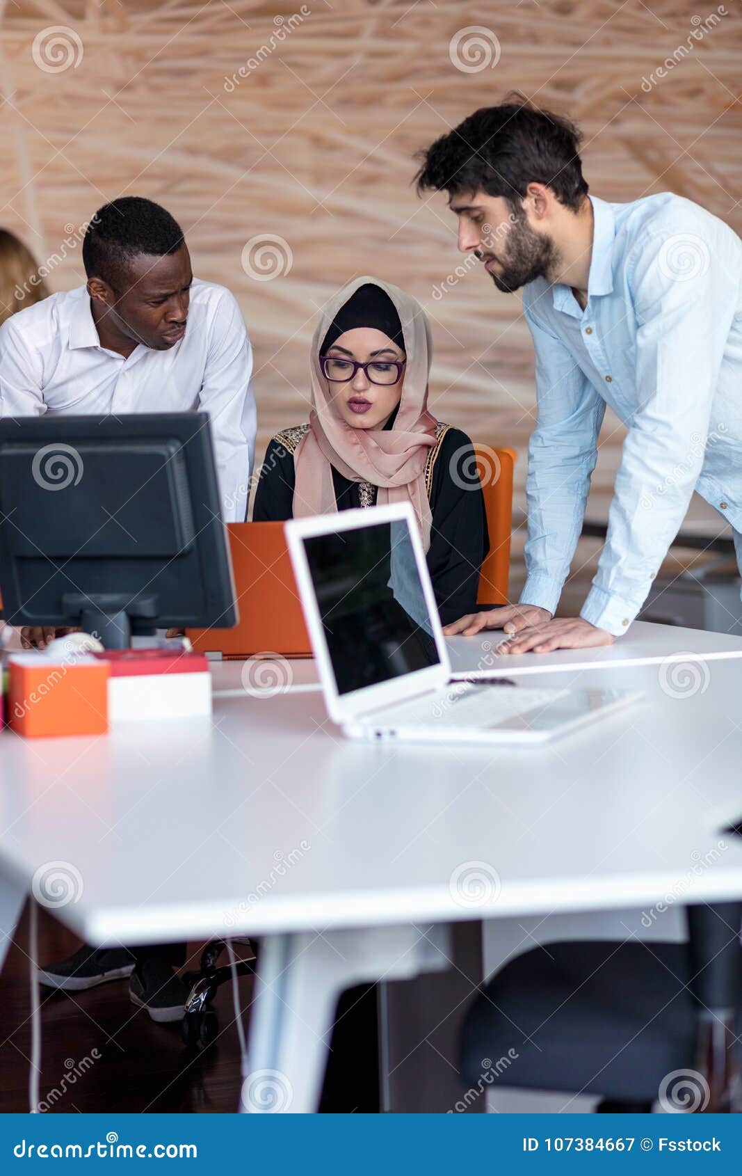 Diverse College Students Using Laptop and Talking, Learning Exchanging