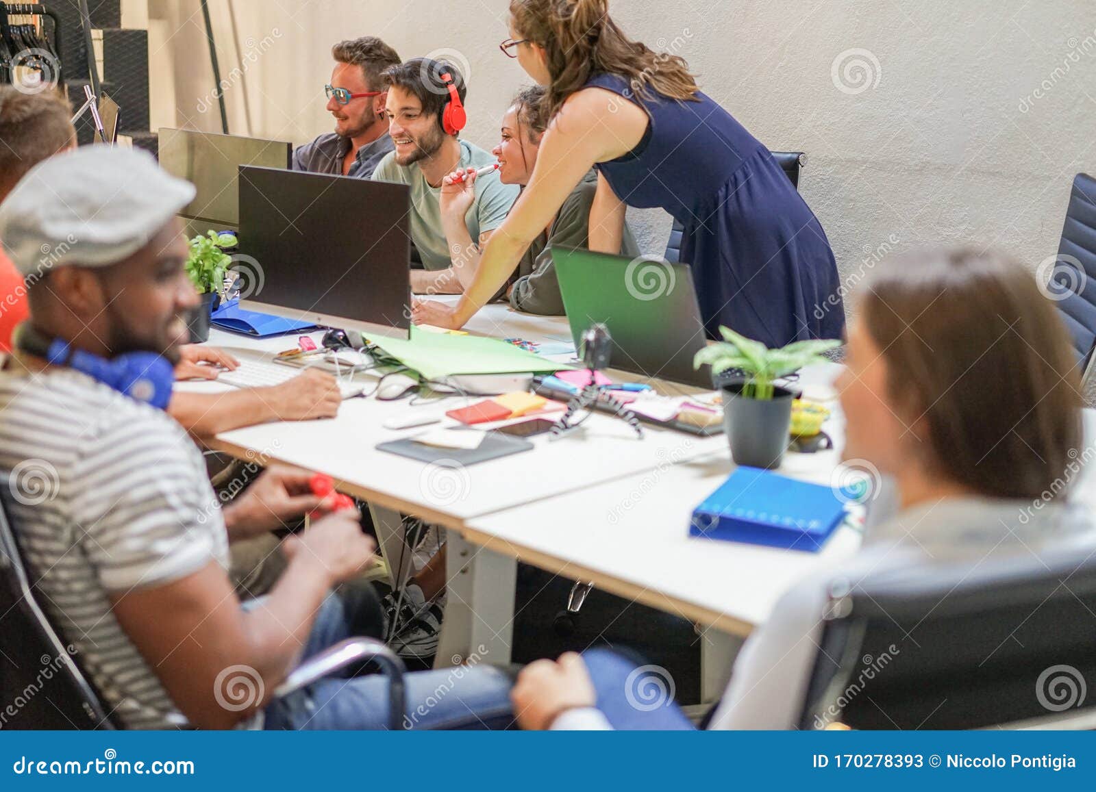 diverse culture people working with computers at startup in creative office - young guys discussing new marketing campaign -