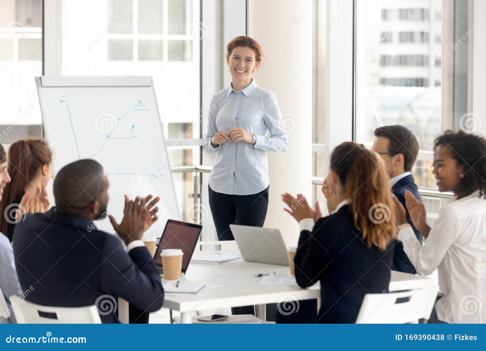 diverse employees applaud thanking coach for training