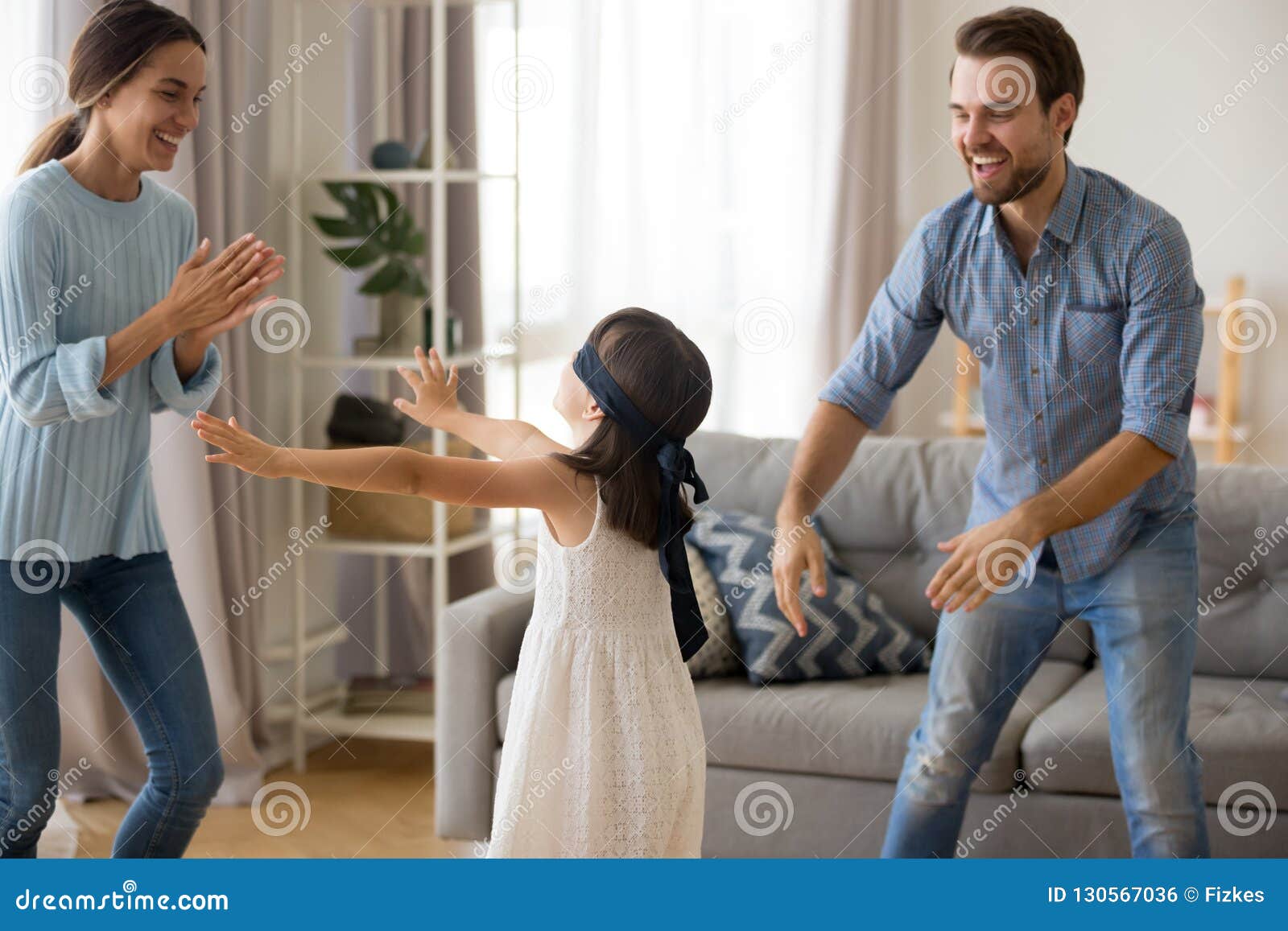 diverse family playing hide and seek at home