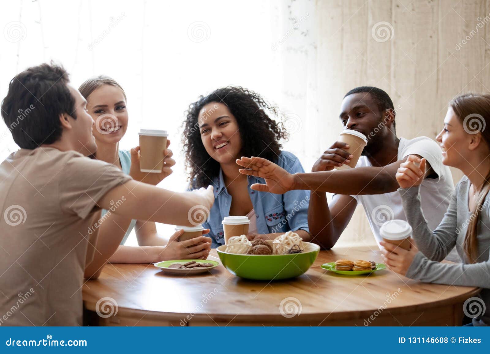 Me And My Friends At The Table Doing Shots Cheerful Diverse Friends Sitting Together at Table Drinking Coff Stock