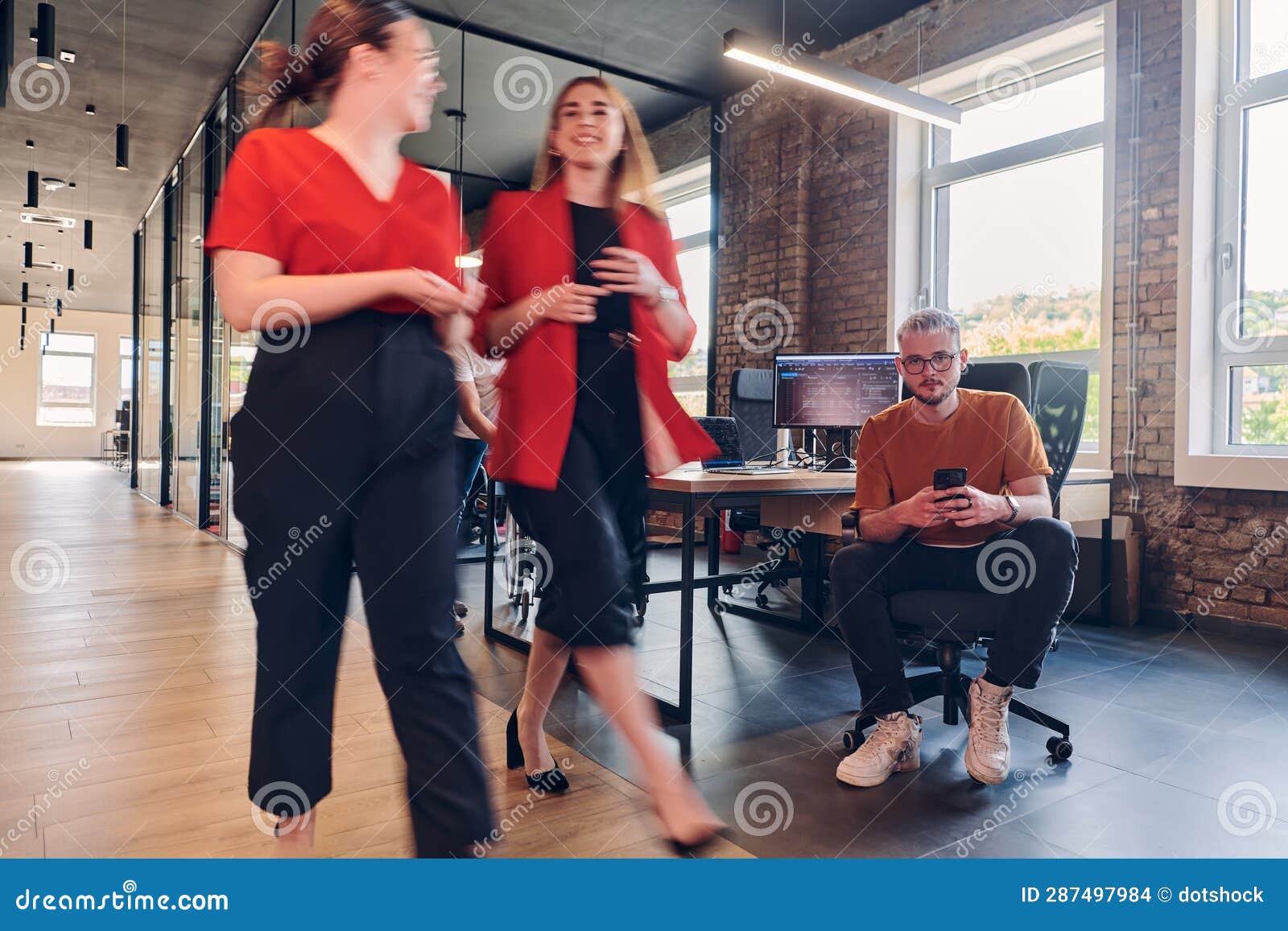 a diverse group of business professionals collaborates in a modern startup coworking center, utilizing a mix of paper