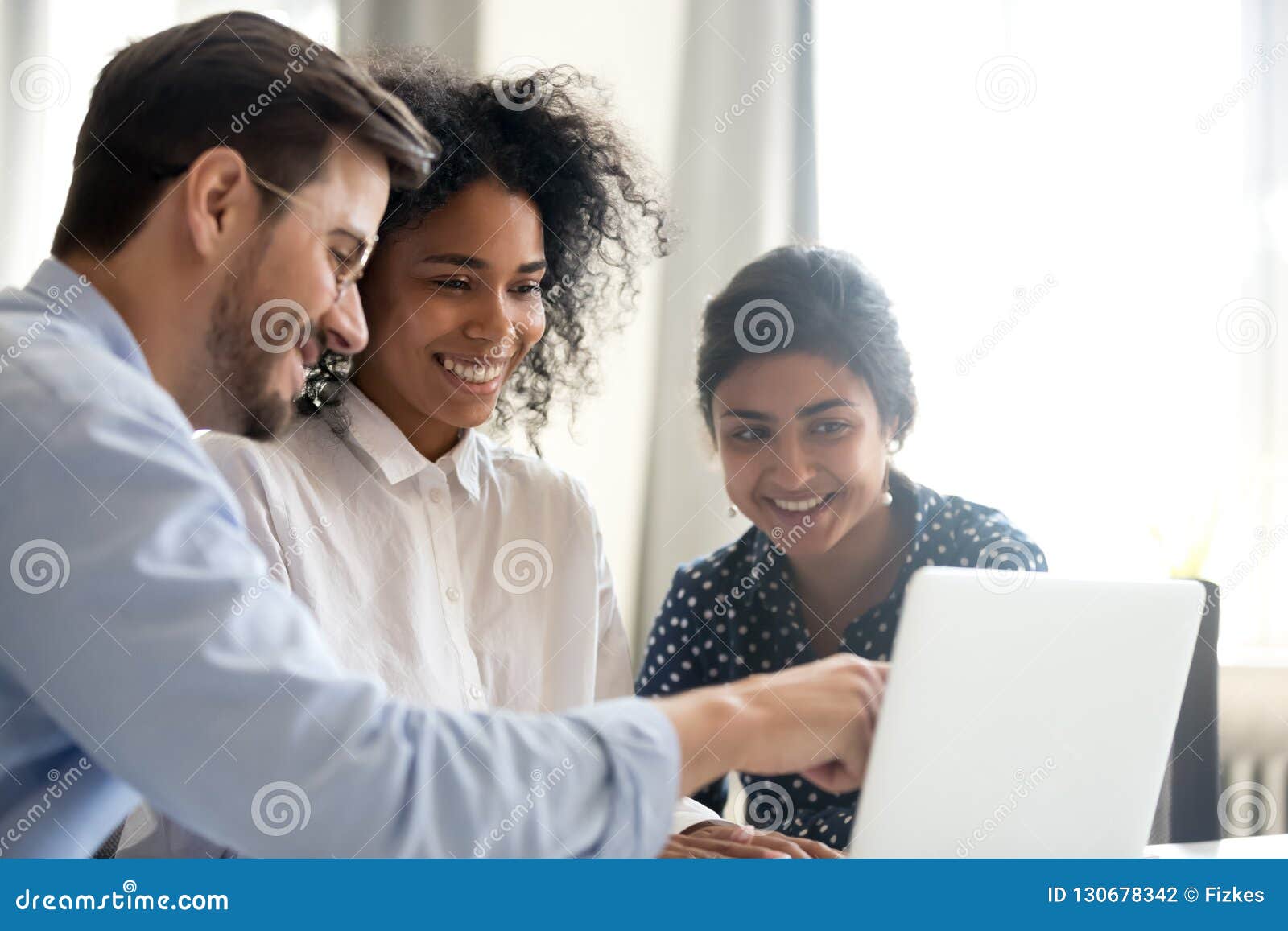 diverse happy interns listening to mentor explaining online proj