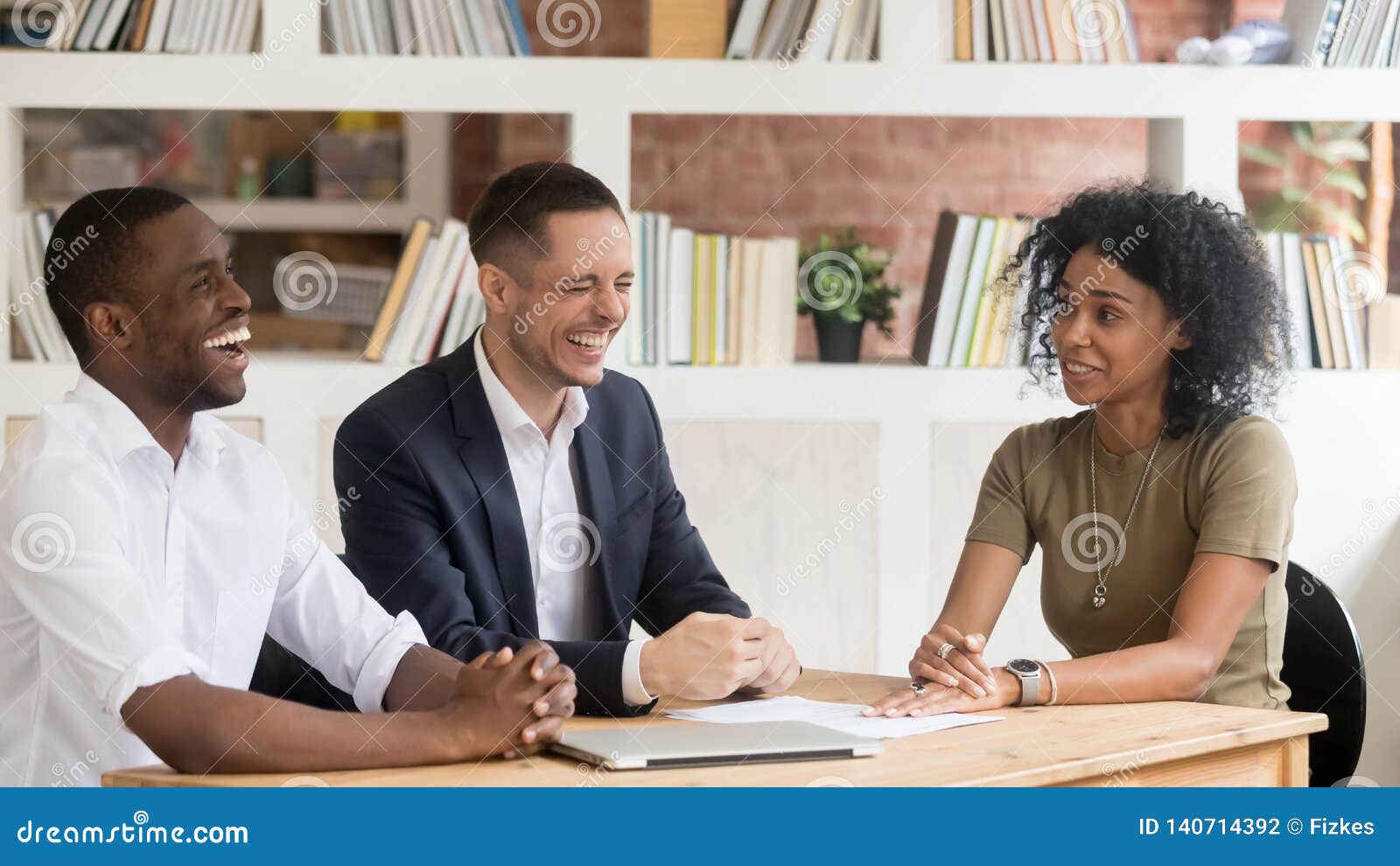 diverse hr managers laughing listening to african applicant at interview