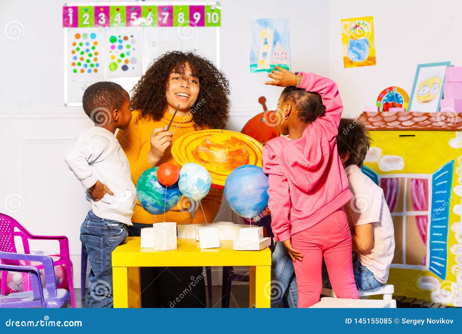 Diverse Kids Group Learn Planets In Nursery School Stock