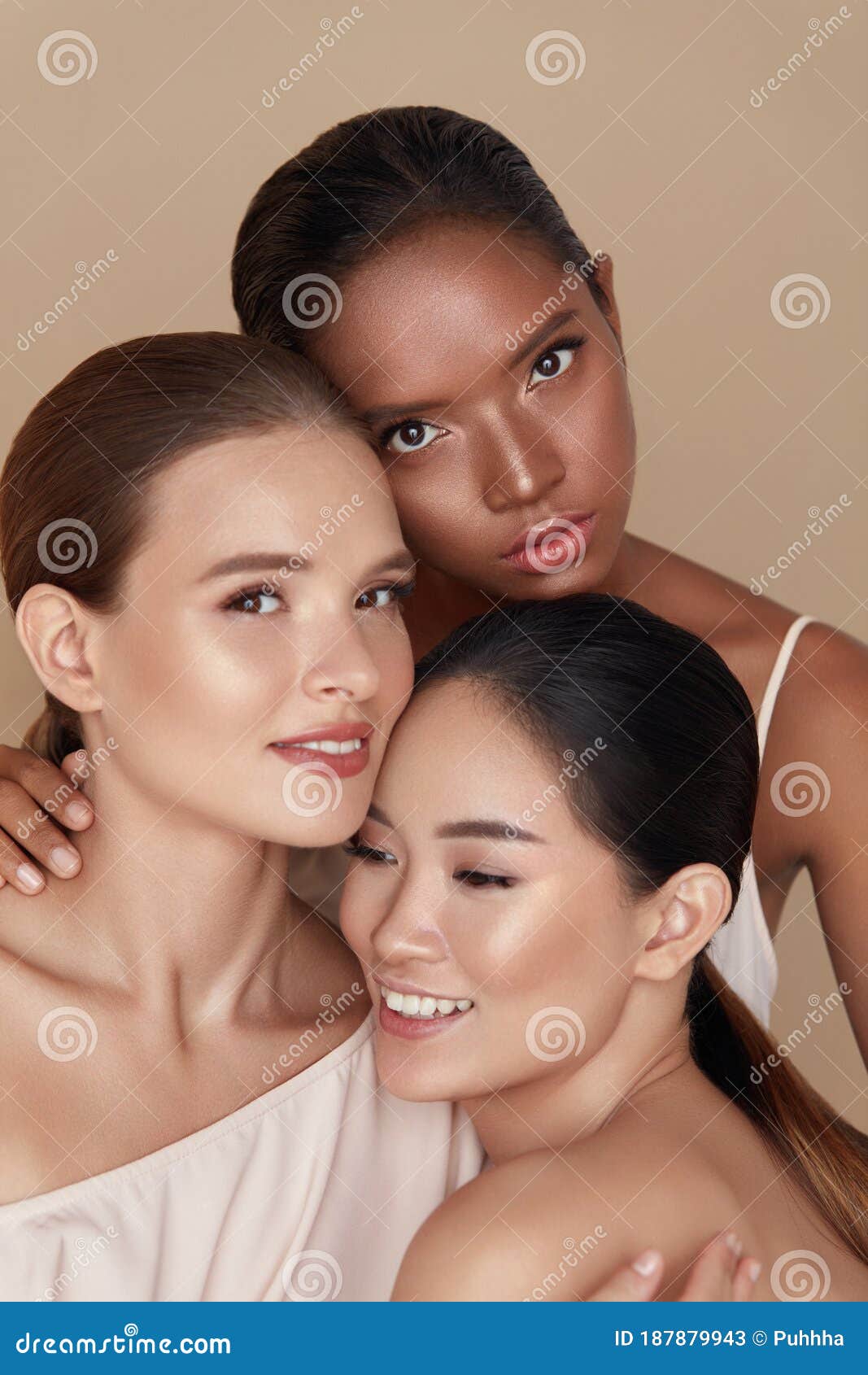 diverse. models beauty portrait. ethnic women with nude makeup and glowing skin standing together against beige background.