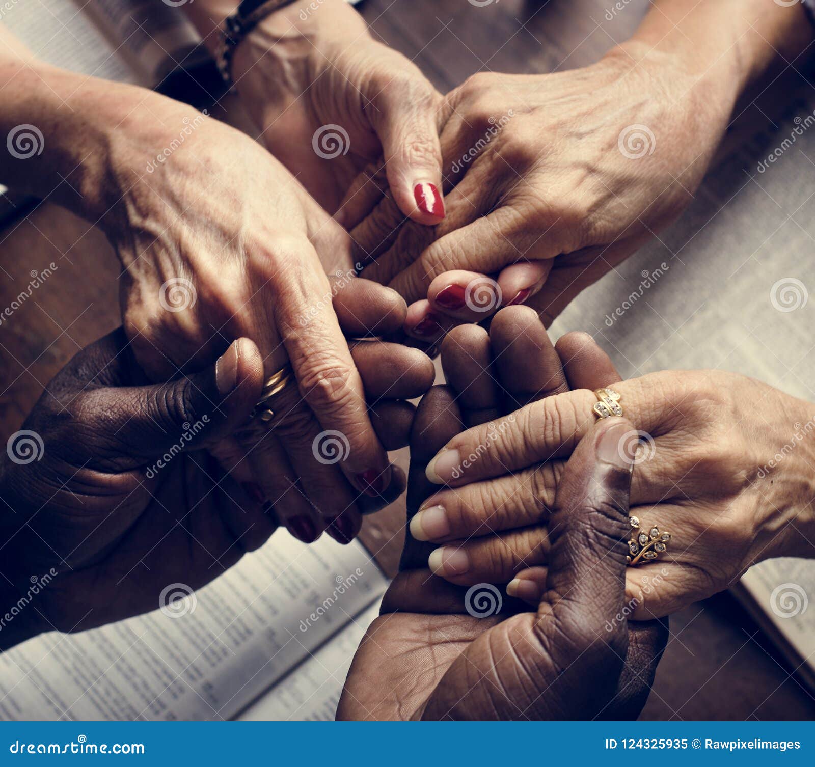 diverse people holding hands religious concept