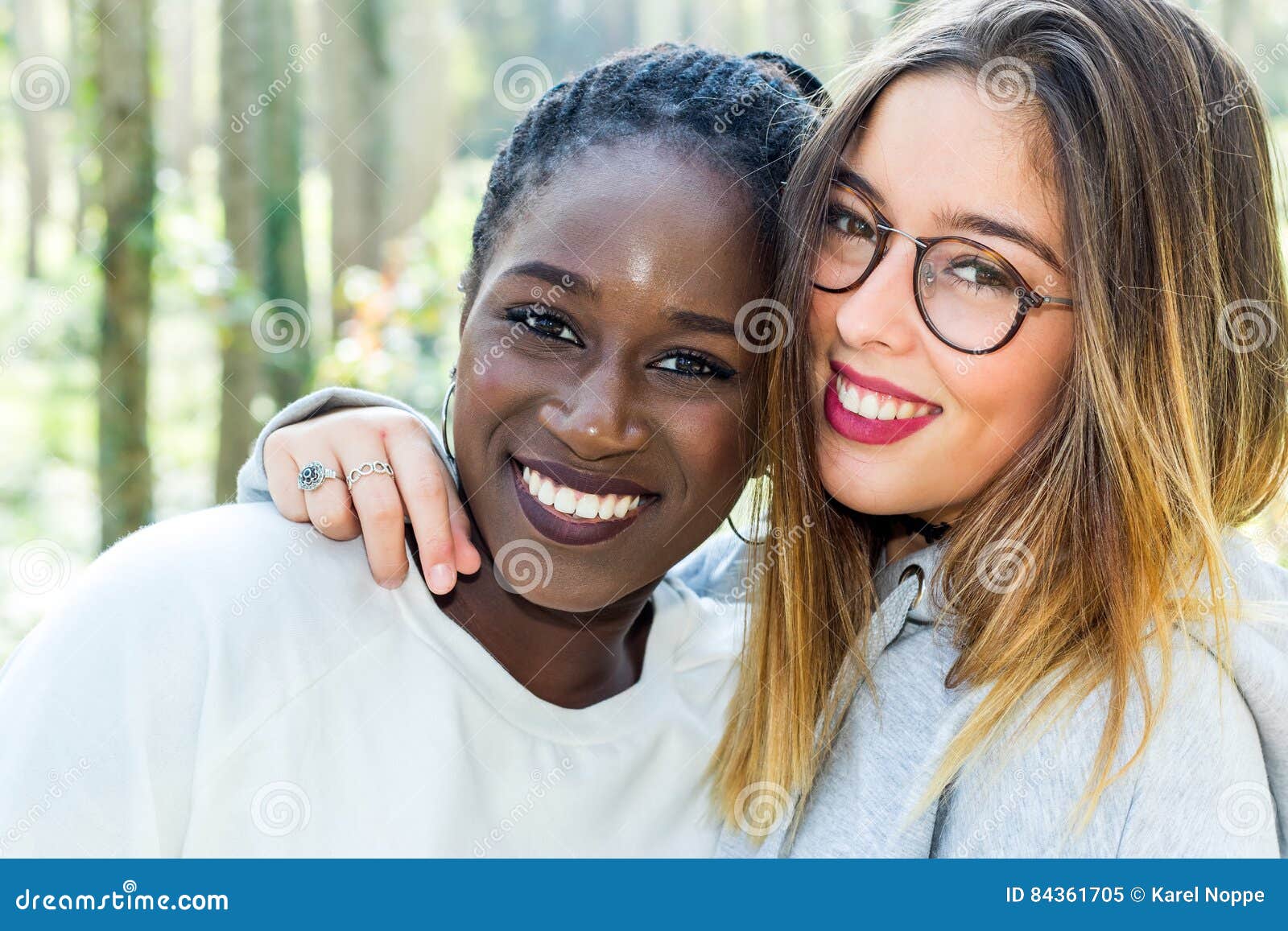 diverse portrait of two attractive teen girlfriends outdoors.