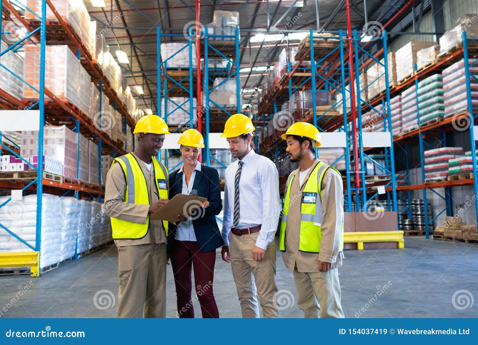 Diverse Staffs Working Together on Clipboard in Warehouse Stock Image