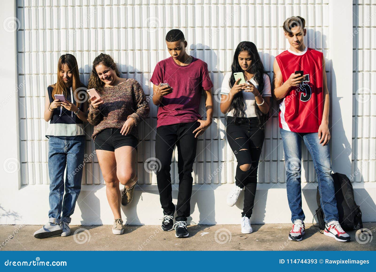 diverse teenagers with their mobile phones