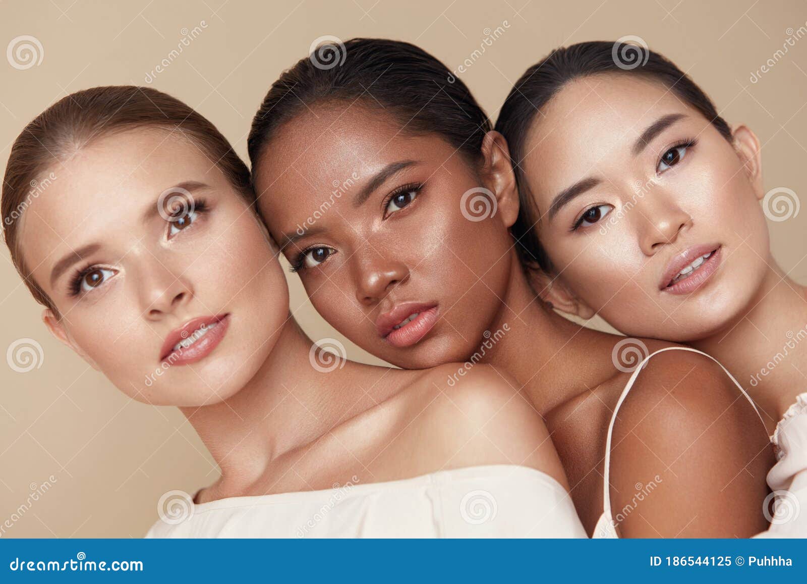 diversity. beauty portrait of different ethnicity women. multi-ethnic models standing together against beige background.