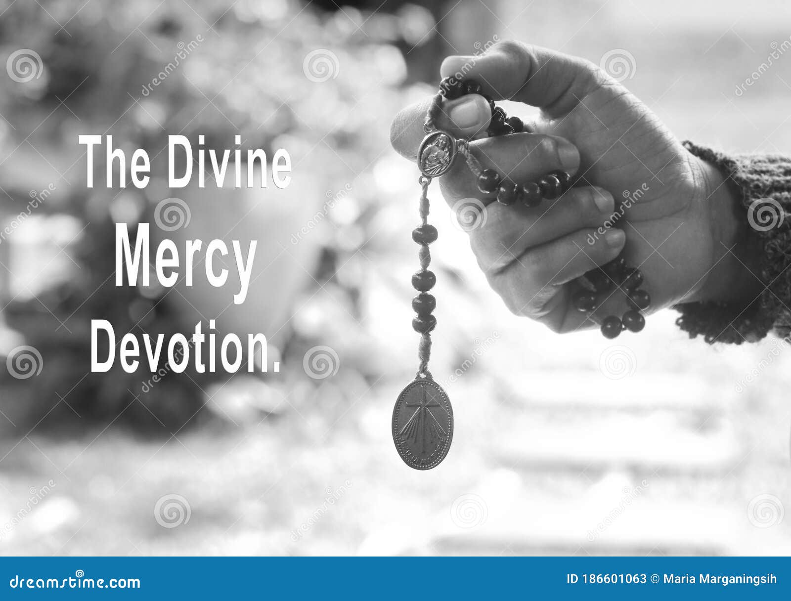 the divine mercy devotion concept with a prayer hand holding the divine mercy rosary beads with the holy heart of jesus christ,