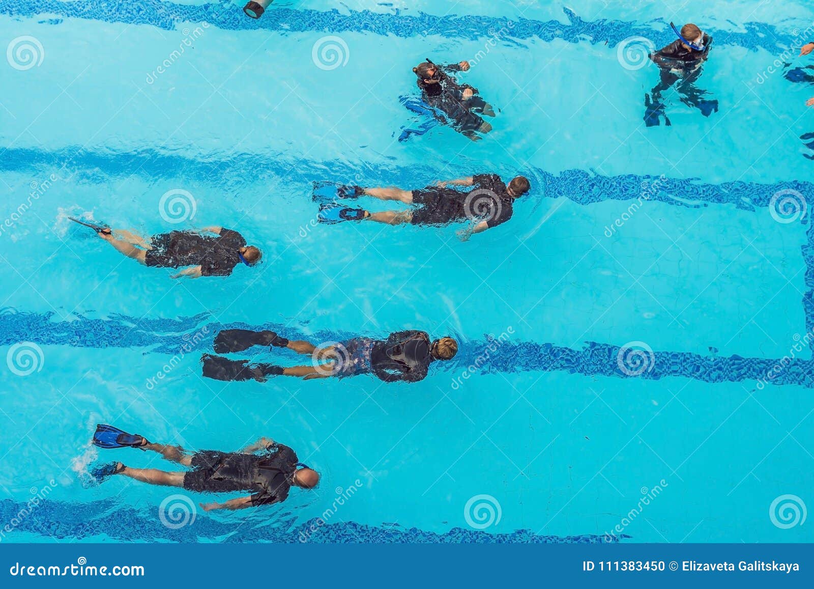 Diving Instructor and Students. Instructor Teaches Students To Dive
