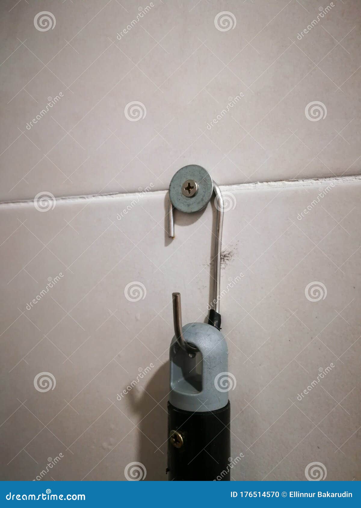 DIY or Do it Yourself Hanging Metal Sticking on the Bathroom Tile Wall