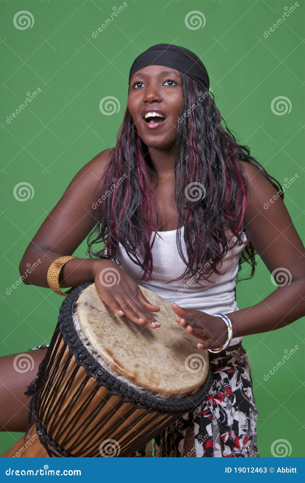 djembe drummer on green