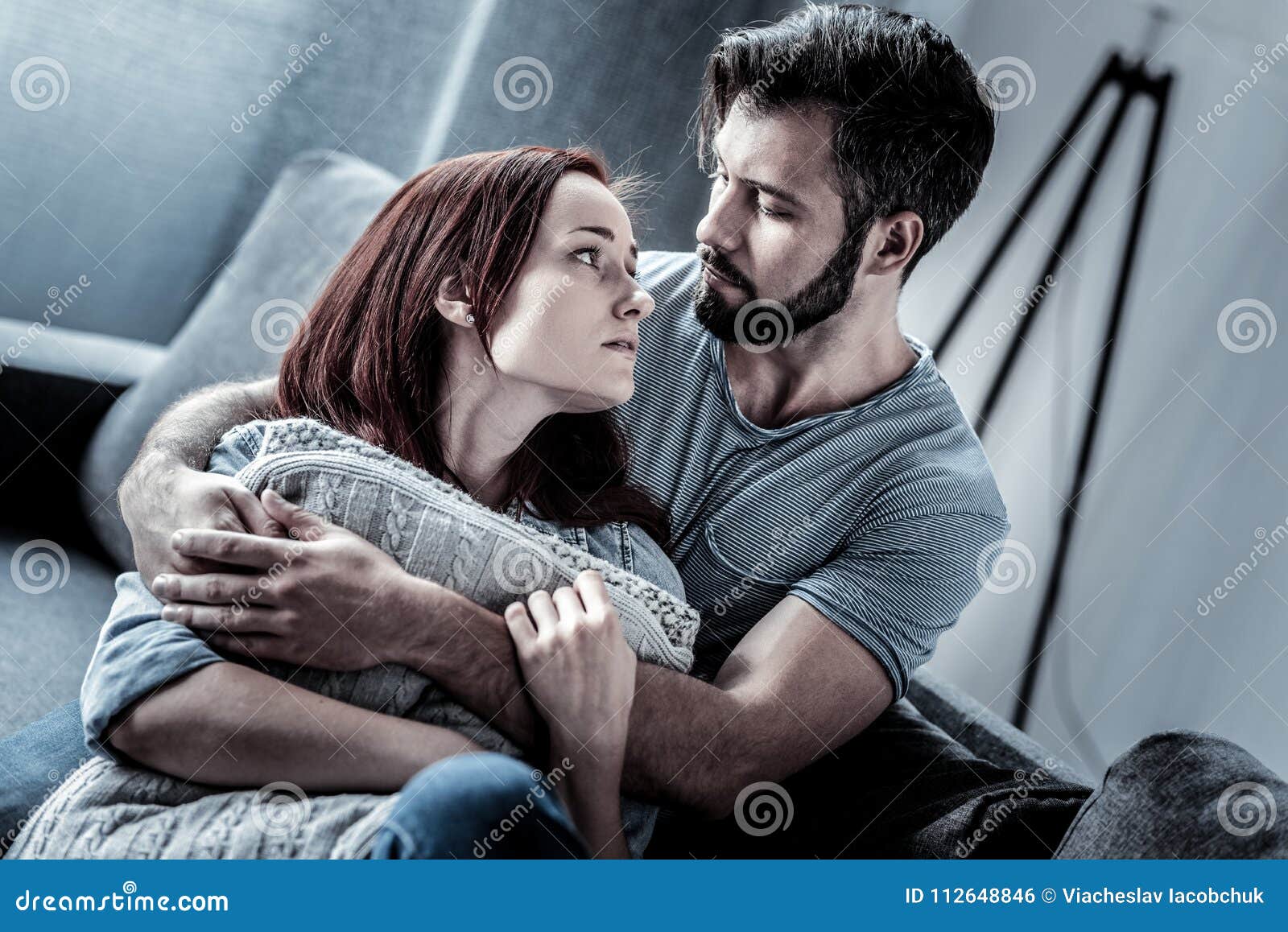 Cute Calm Woman Hugging Pillows and Looking at Her Husband. Stock Photo ...