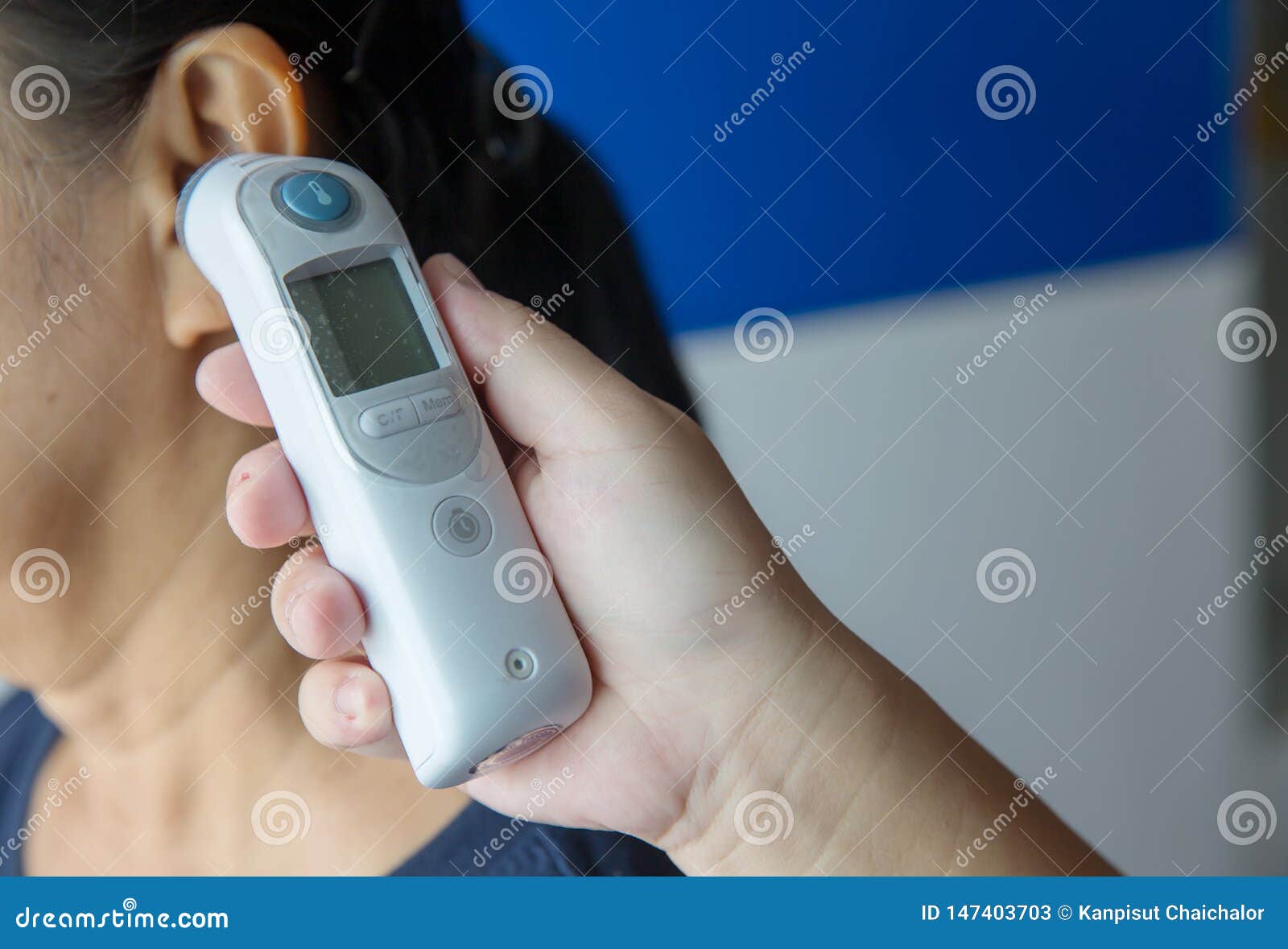 Doctor Checking Patient`s Temperature in the Ear with Tympanic